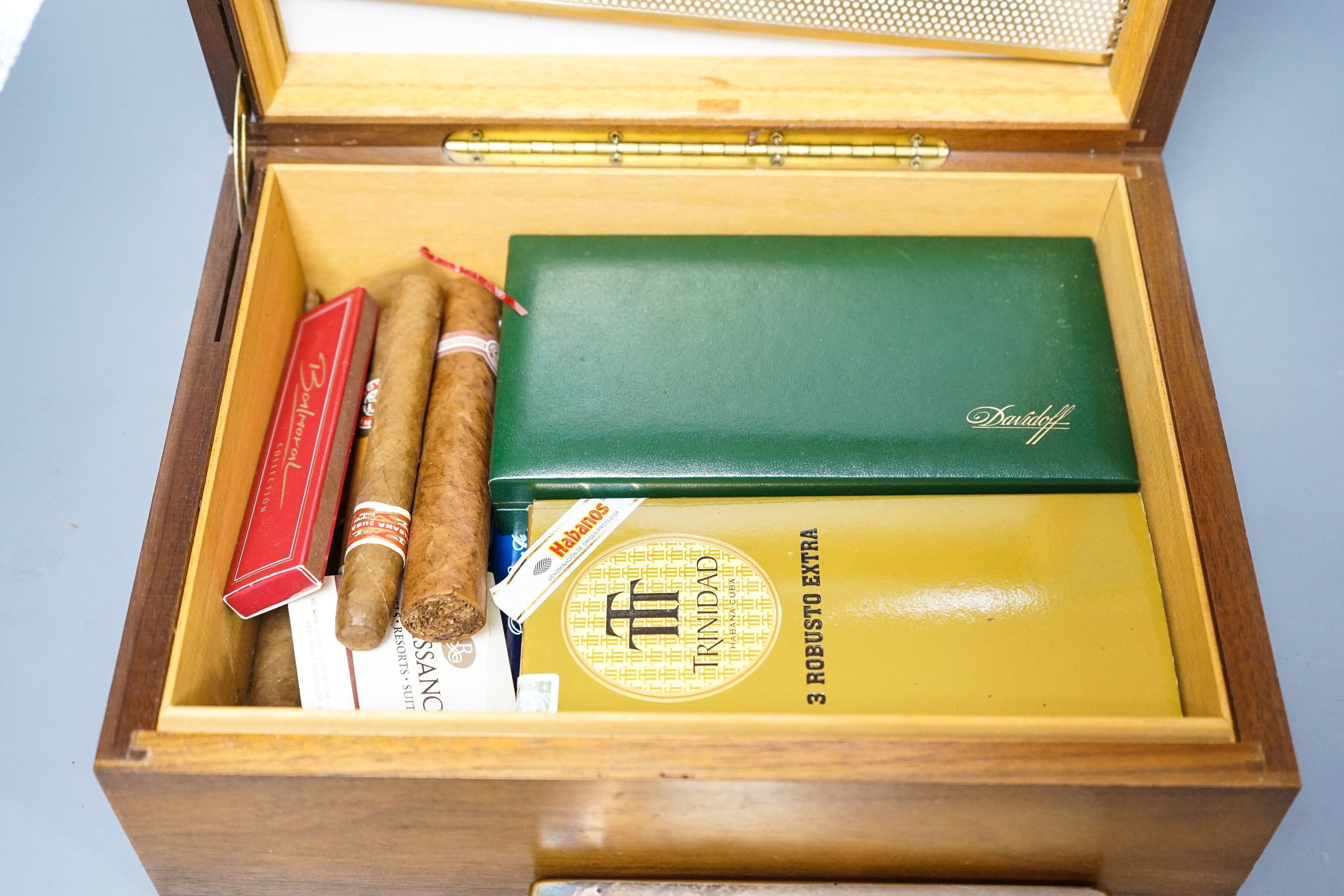 A cased Davidoff cigar cutter, walnut humidor, plated cigarette box, various cigars etc.
